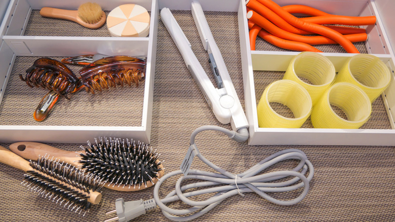 A drawer of hair tools and accessories.