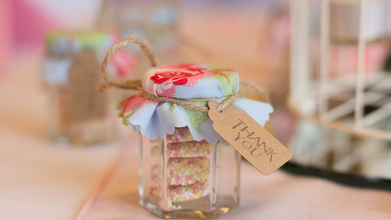 Jar with floral fabric secured on the top