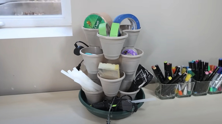 Stackable planters being used as craft supply storage and organization on a desk.