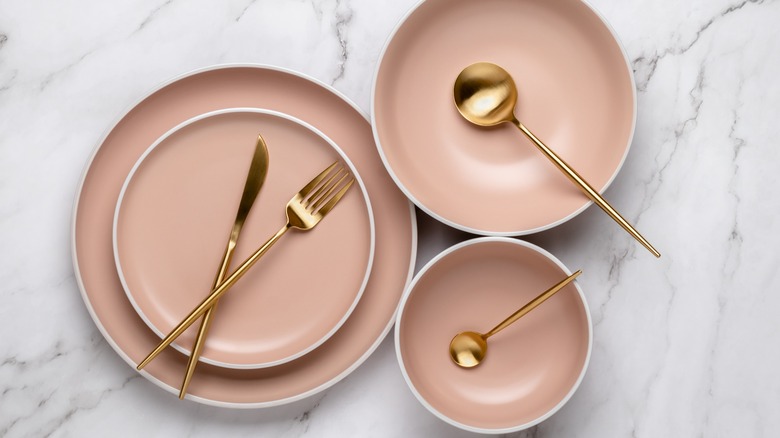 Gold cutlery with pink plates