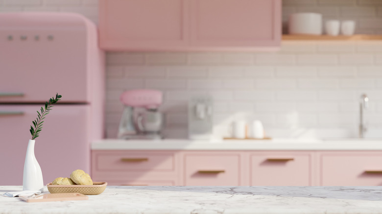 kitchen with pink cabinets and refrigerator