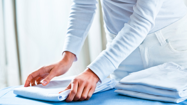 person folding a shirt 