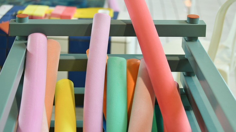 assorted pool noodles in store basket