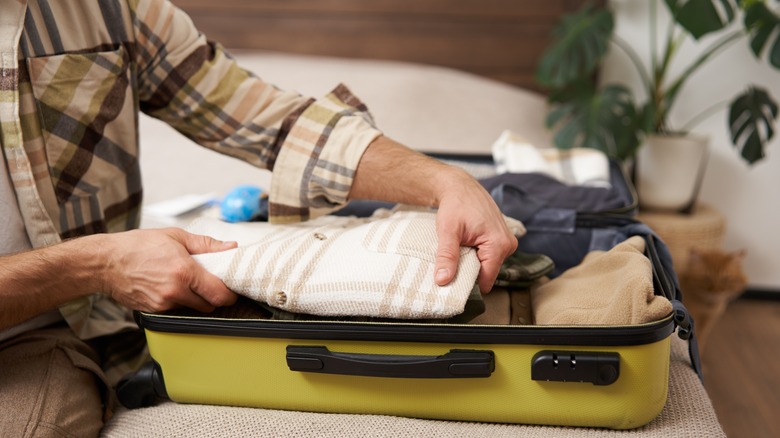 Person packing suitcase