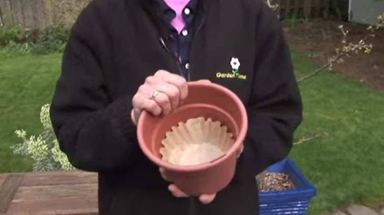 Woman lining planter with filter