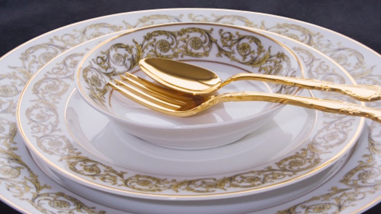 White and gold china place setting