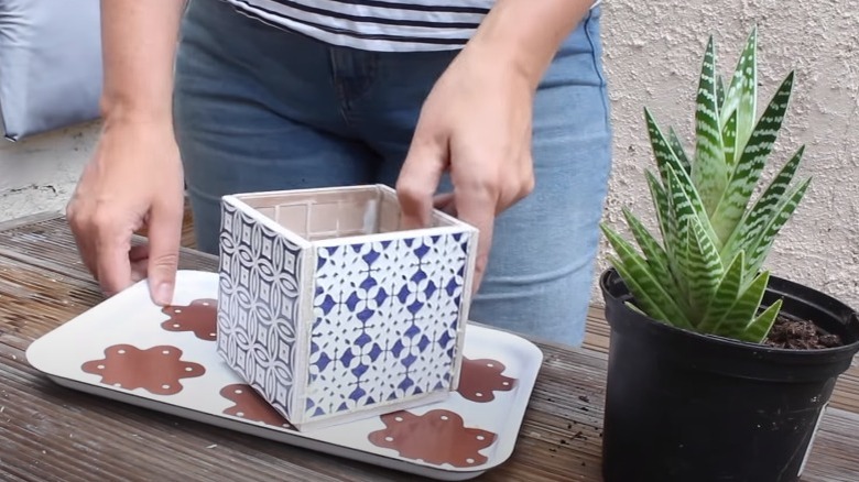 person holding tile cube