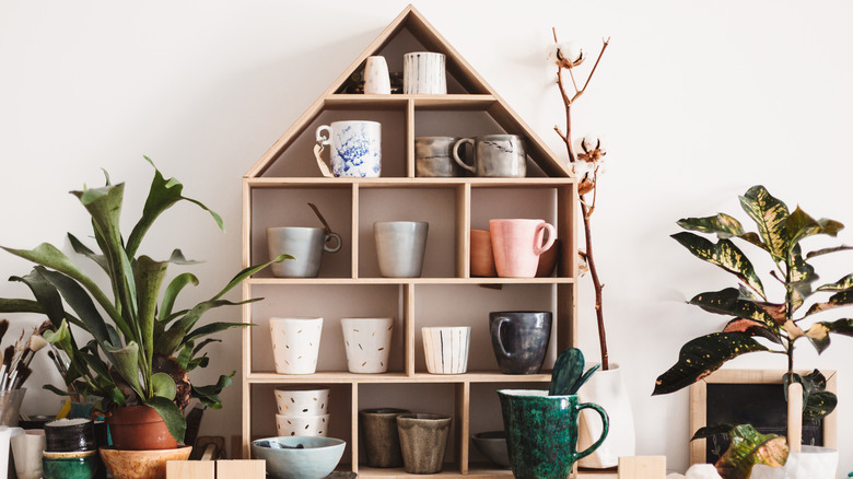 mugs on house-shaped shelving