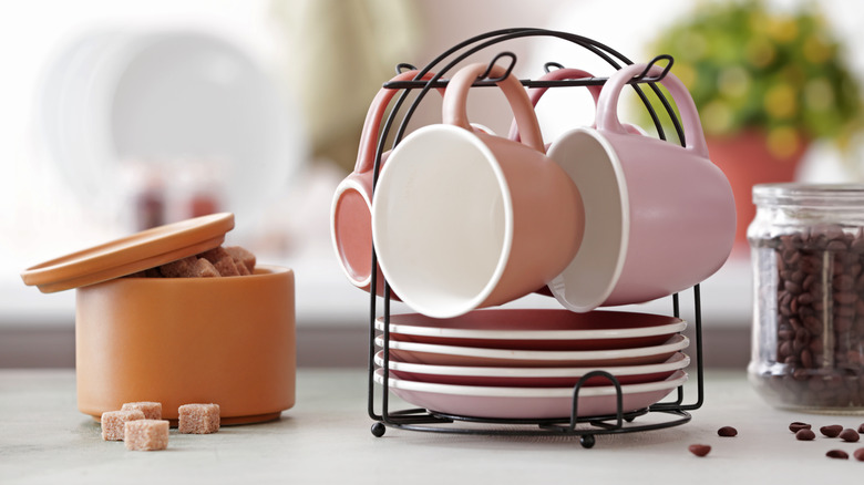 pink mugs on rack 