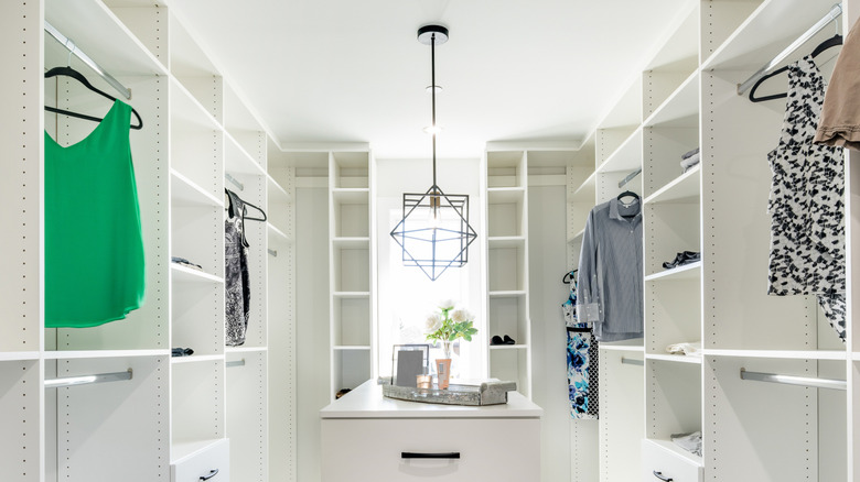 Modern closet with a stylish pendant light hanging over vanity table