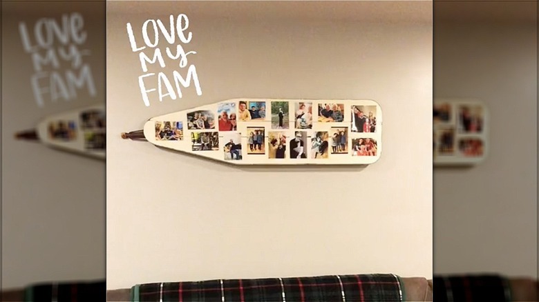 ironing board with photos on wall