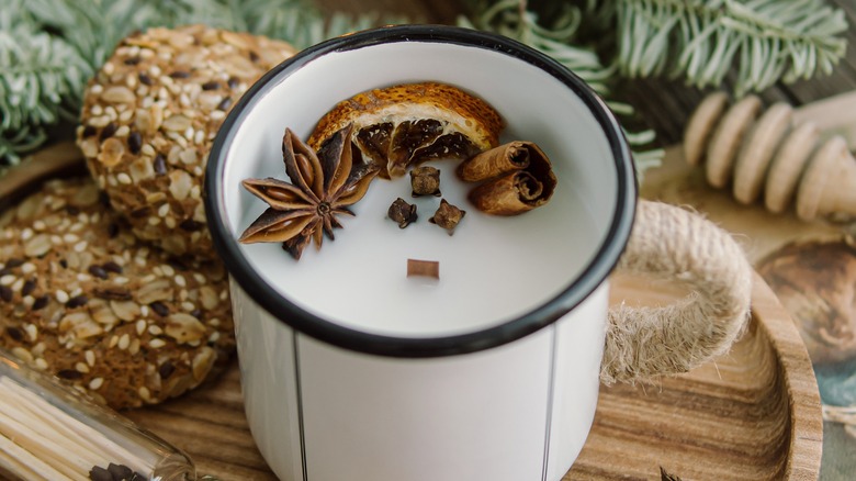 white candle in white mug