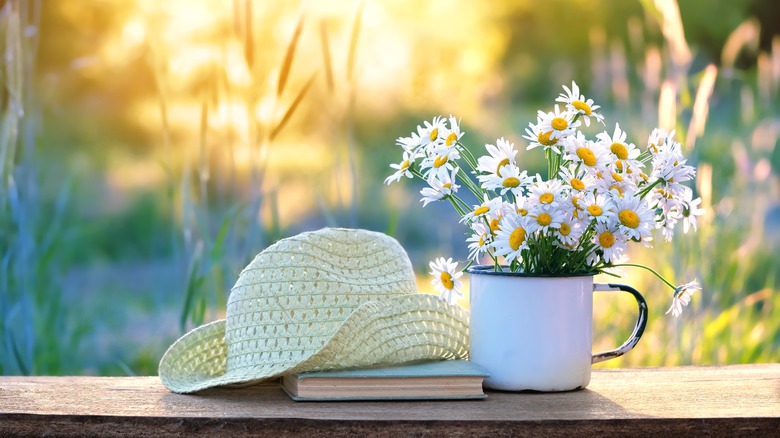 flowers in mug by hat