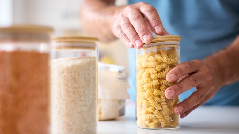 Person filling glass jars