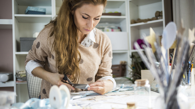 Woman cutting up paper