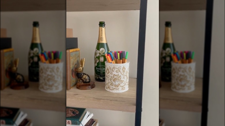 decorated paint can on bookshelf