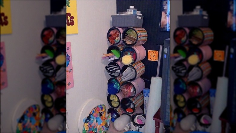 stacked paint cans filled with items