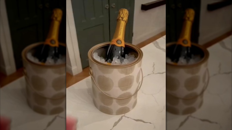 champagne bottle and ice in paint can
