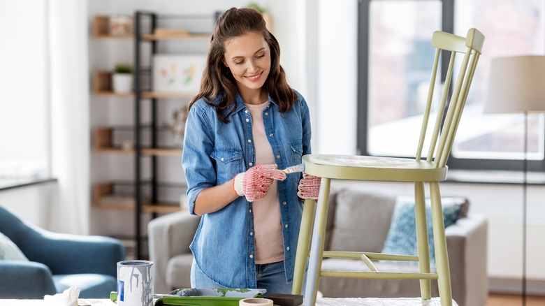 woman painting a chair