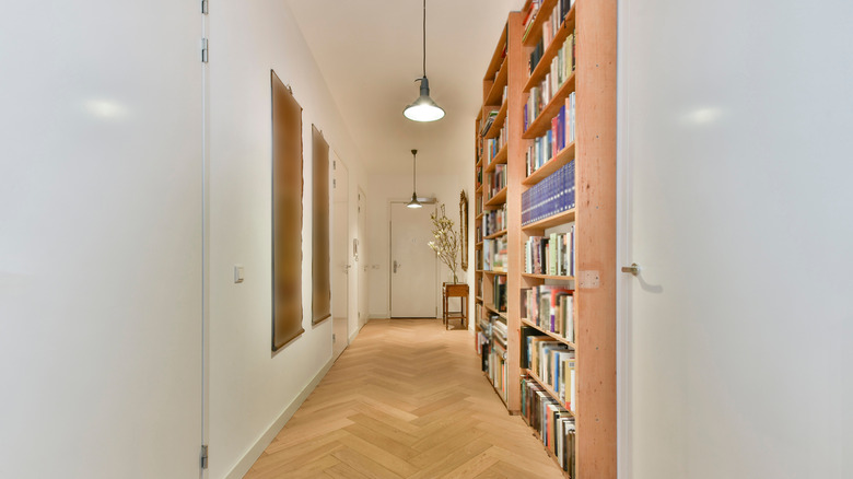 Hallway with bookcase and pendants