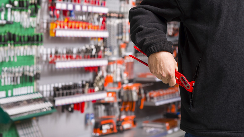 Man shoplifting wrench