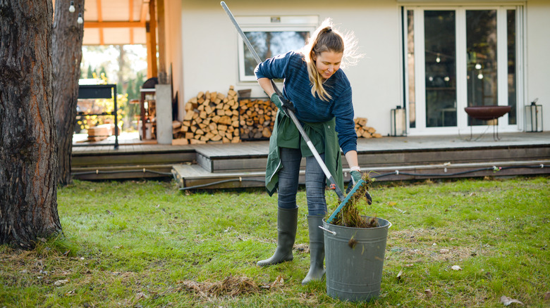 woman cleaning up lawn