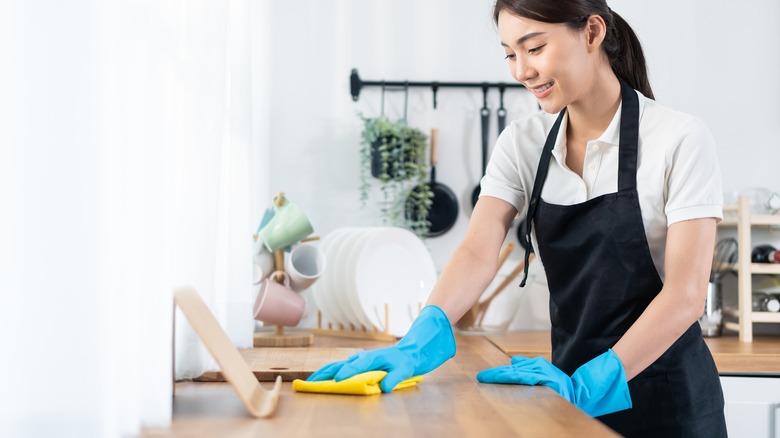 woman cleaning countertops