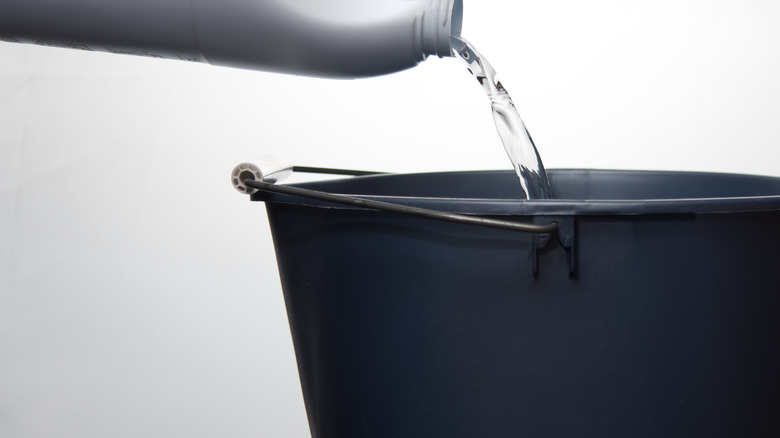 Bleach pouring into bucket