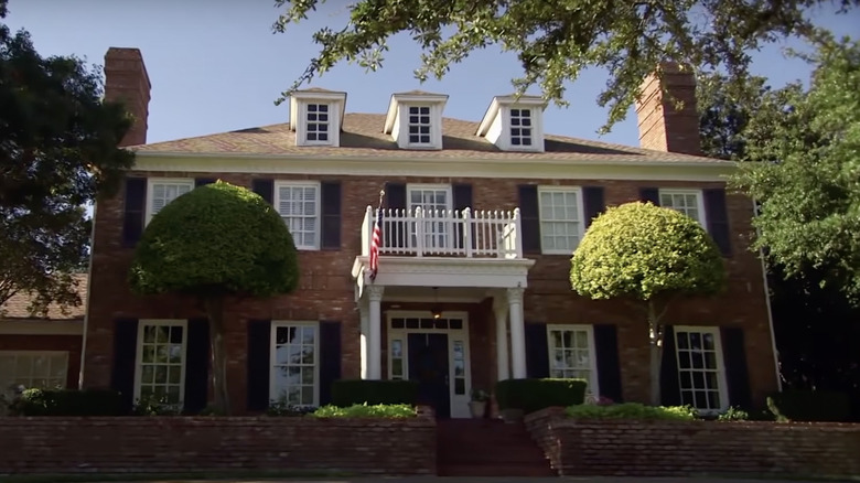 colonial style home with flag