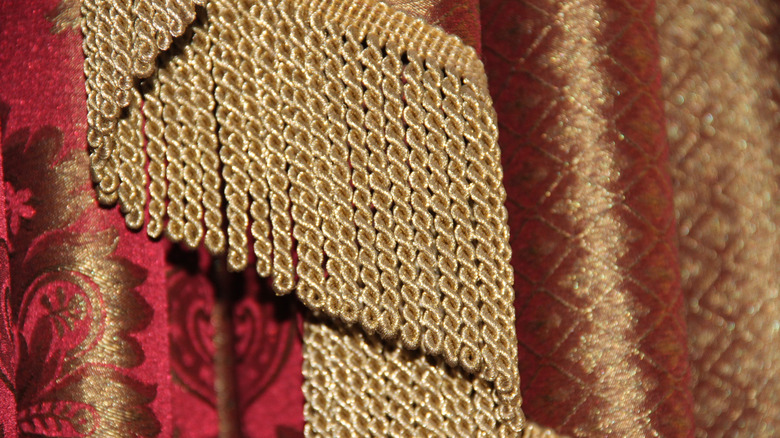 gold bouillon fringe with red curtain