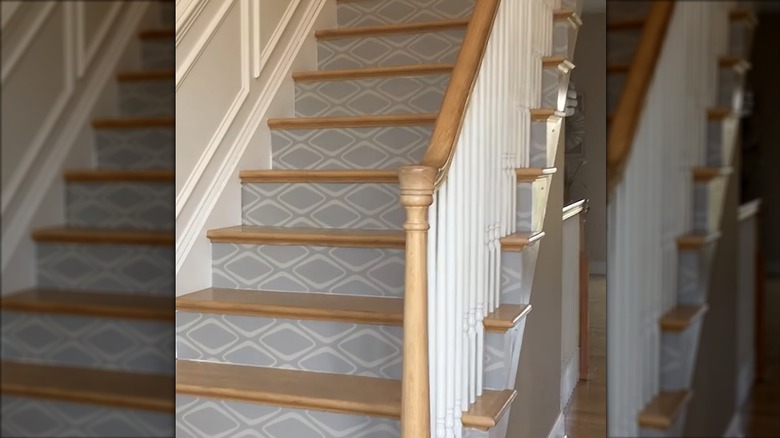 Staircase in home with gray wallpaper design on the stair risers