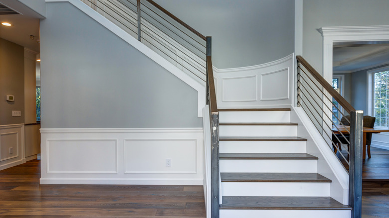 Staircase in modern home with wainscot molding wall design