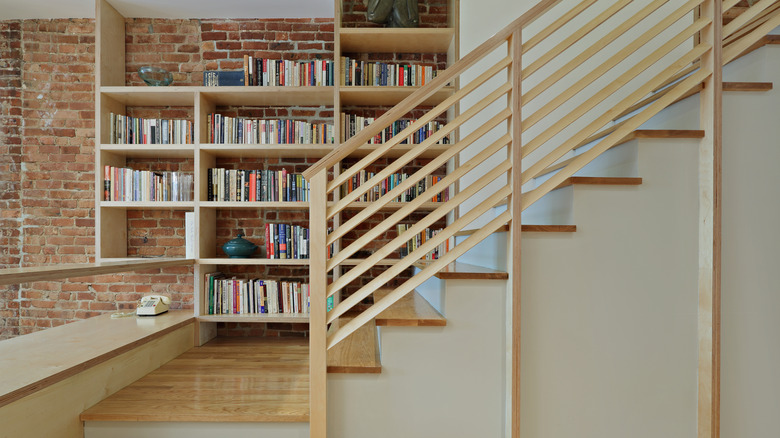 Built-in bookshelf wall on staircase in a home