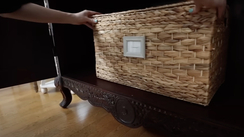 Person adding basket with mini framed label to cabinet