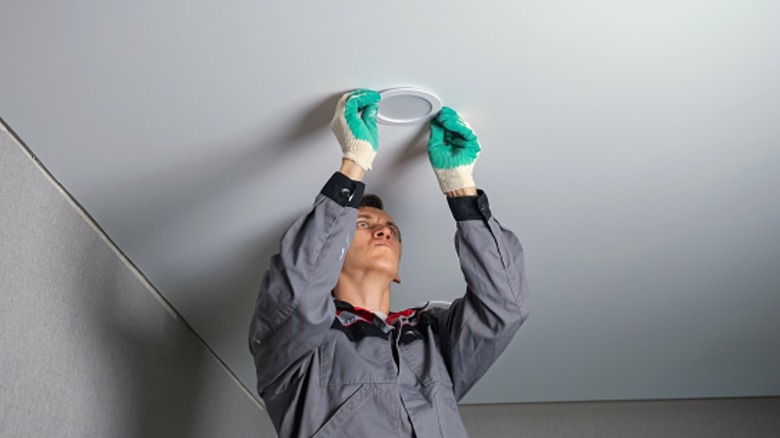 Man installing ceiling light