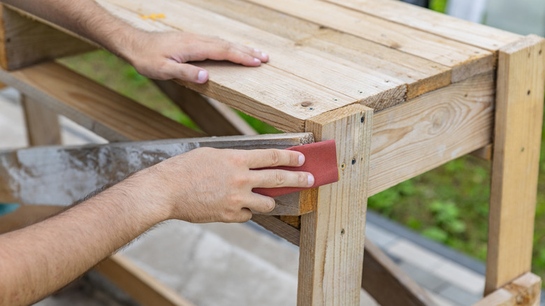 Person sanding down furniture edges