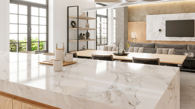 a bright kitchen featuring a marble counter