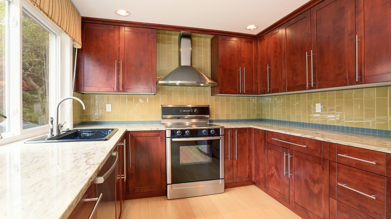 a kitchen with dark stained wood cabinets