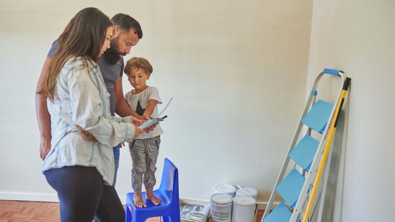 Parents and child choosing paint color