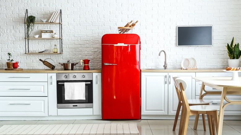 Red retro fridge in a white kitchen