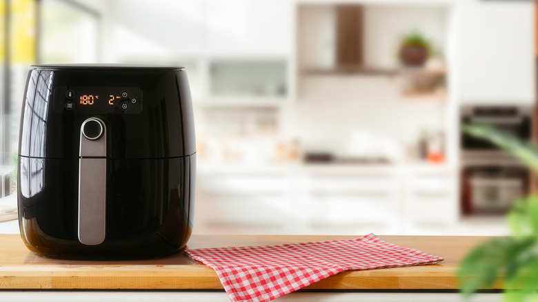 Black air fryer on a kitchen counter