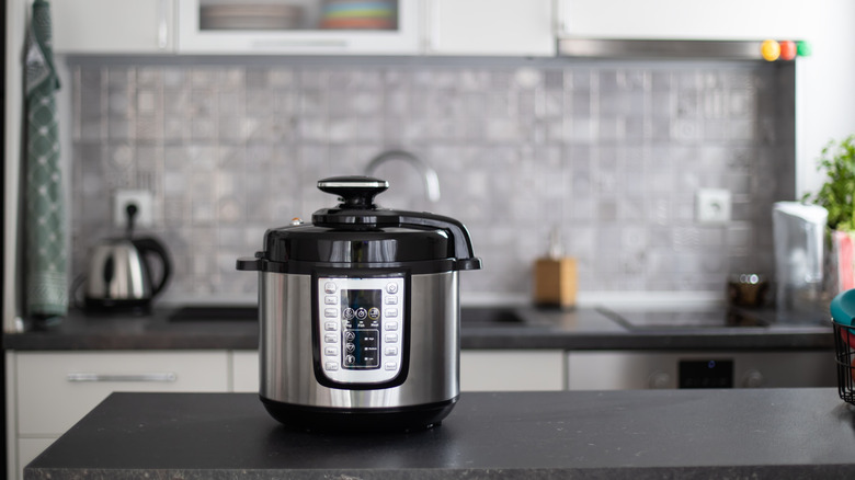 Black and stainless steel multi-cooker on a kitchen counter