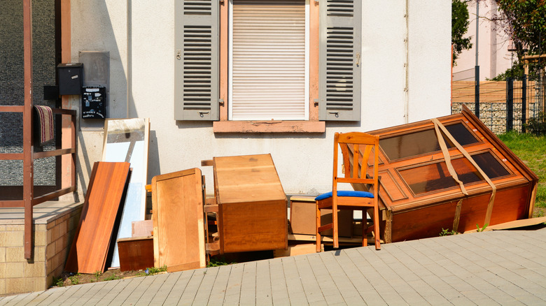 old wooden furniture laying on paved street