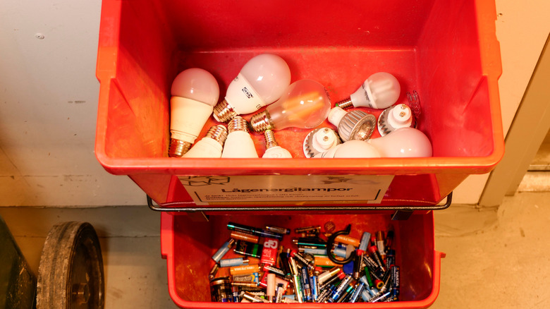 batteries and lightbulbs in red bins