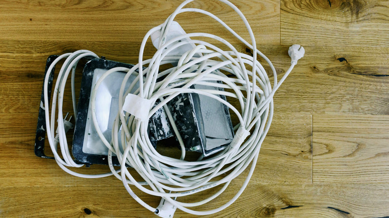 pile of projector cords on wood floor