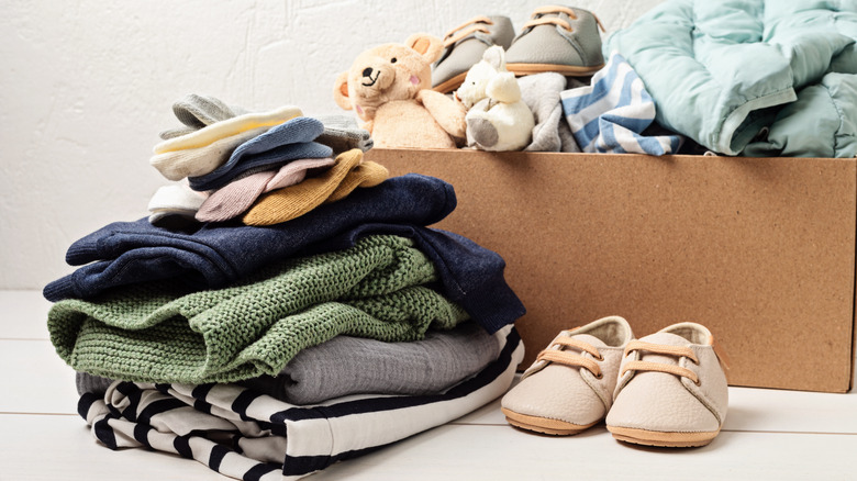 pile of children's clothes, shoes, and toys in box