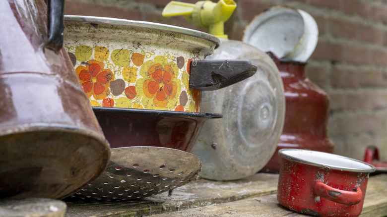 dirty and rusted cookware on a table