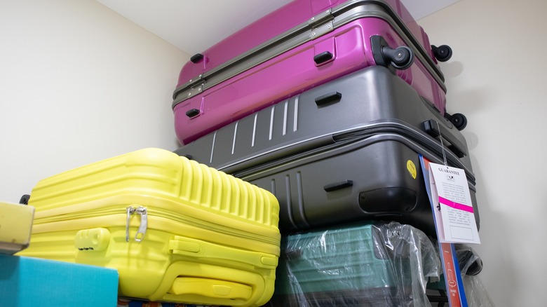 suitcases stacked up in a basement