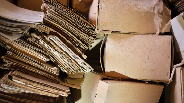 old paperwork in folders and boxes piled up