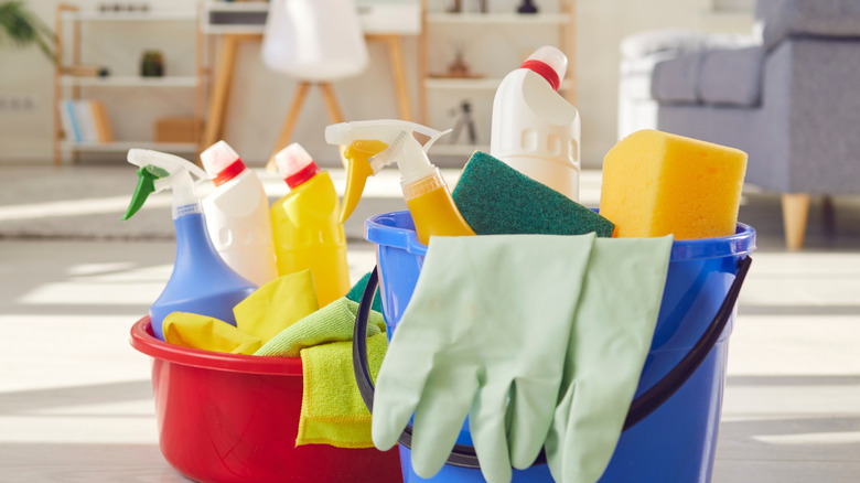 Cleaning supplies in red and blue buckets